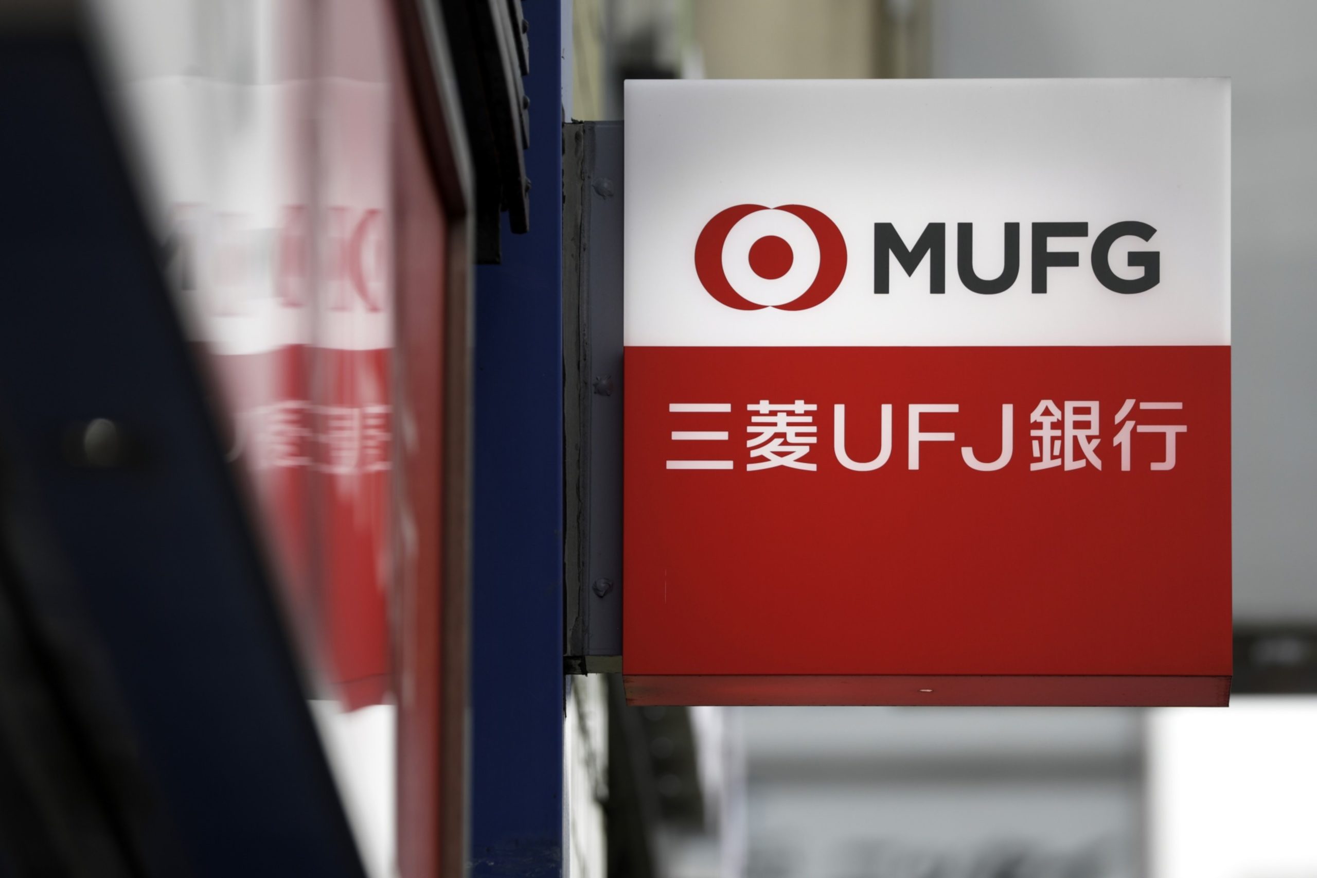 Signage for MUFG Bank Ltd., a unit of Mitsubishi UFJ Financial Group Inc. (MUFG), is displayed outside a branch in Tokyo, Japan, on Wednesday, May 13, 2020. 
 Photographer: Kiyoshi Ota/Bloomberg Photographer: Kiyoshi Ota/Bloomberg