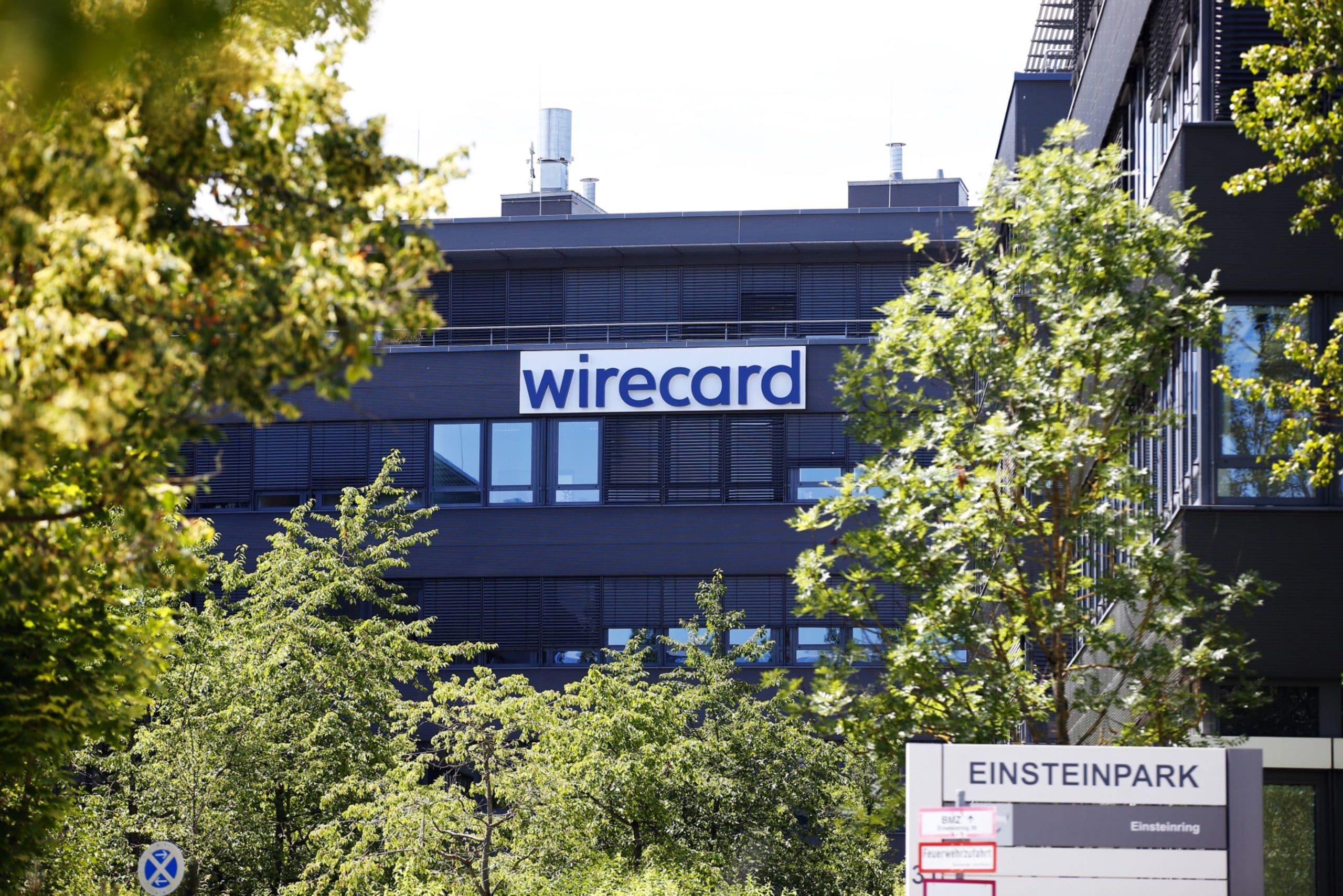 The Wirecard AG logo sits on the company's headquarters during a raid with prosecutors in Munich, Germany, on Wednesday, July 1, 2020. Wirecard offices in Germany and two locations in Austria were raided by Munich prosecutors looking into the 1.9 billion euros ($2.1 billion) that went missing from the fintech companys accounts.