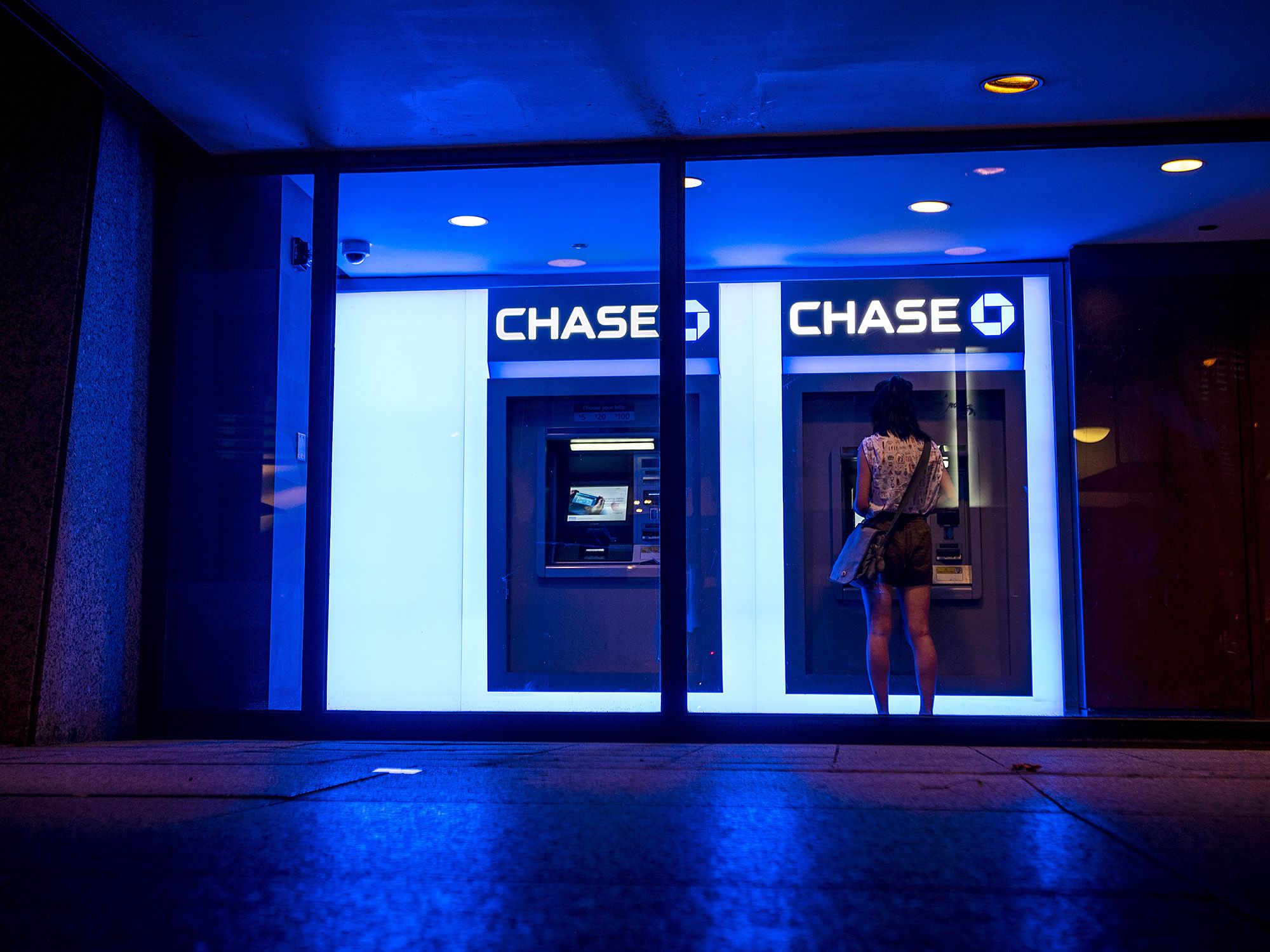 A customer uses an automatic teller machine (ATM) at a JPMorgan Chase & Co. bank branch in Chicago. Photographer: Christopher Dilts/Bloomberg