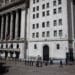 A trader walks in front of the New York Stock Exchange. Photographer: Michael Nagle/Bloomberg