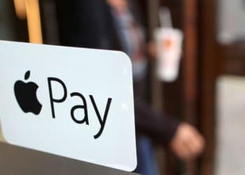 A sign for the launch of the Apple pay system, from Apple.Inc is seen displayed at the entrance to a McDonald's Corp. restaurant in London, U.K. Photographer: Chris Ratcliffe/Bloomberg