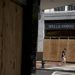 A pedestrian wearing a protective mask walks past a boarded up  Wells Fargo & Co. bank branch in Washington, D.C., U.S., on Thursday, June 4, 2020. Photographer: Andrew Harrer/Bloomberg