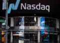 Signage is displayed outside the Nasdaq Market Site in the Times Square area of New York. Photographer: Demetrius Freeman/Bloomberg Mercury