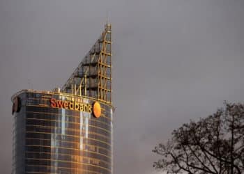 The logo of Swedbank AB bank on a tower block in Riga, Latvia, on Sunday, Oct. 30, 2022. For the Baltics, Moscow will remain a threat in eastern Europe regardless of the outcome of the war, with no indication that Kremlins foreign policy will change, Mikk Marran, Estonias outgoing espionage chief, said. Photographer: Andrey Rudakov/Bloomberg