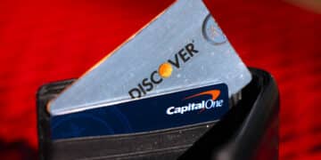 Capital One and Discover credit cards arranged in Rhinebeck, New York, US, on Tuesday, Feb. 20, 2024. Capital One Financial Corp. agreed to buy Discover Financial Services in a $35 billion all-stock deal to create the largest US credit card company by loan volume, giving the combined entity a stronger foothold to compete with Wall Streets behemoths.